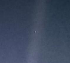 The Pale Blue Dot — Earth as a tiny bluish speck within a sunbeam, the last photograph Voyager 1 ever took, 1990